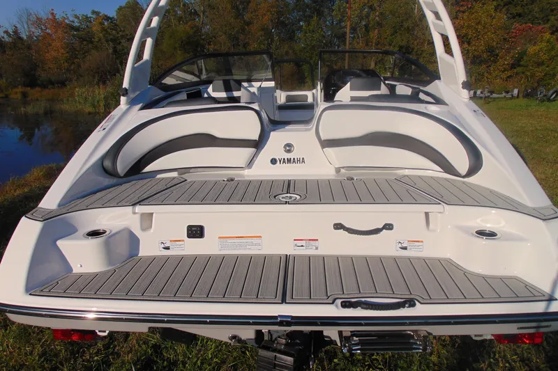 Slide: The Image of 2026 Yamaha Boats 195S, rear view, sleek design, spacious seating, outdoor setting. - 16
