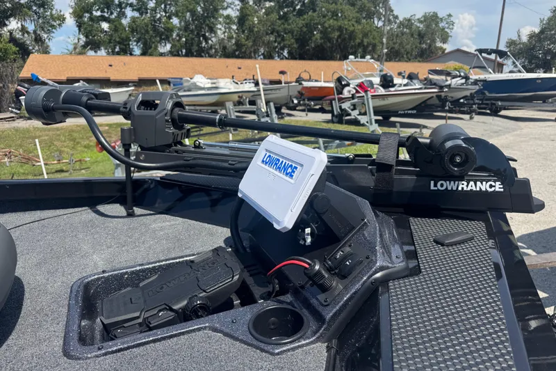 Slide: The Image of 2025 Ranger RT188P boat with Lowrance electronics and trolling motor, parked outdoors. - 4