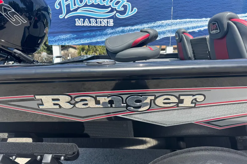 Slide: The Image of 2025 Ranger RT188P boat with logo, black and red seats, Holiday Marine backdrop. - 7