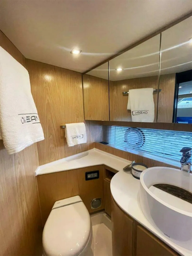Slide: The Image of Luxurious bathroom in 2025 OKEAN 52 yacht with modern fixtures and elegant wood paneling. - 16