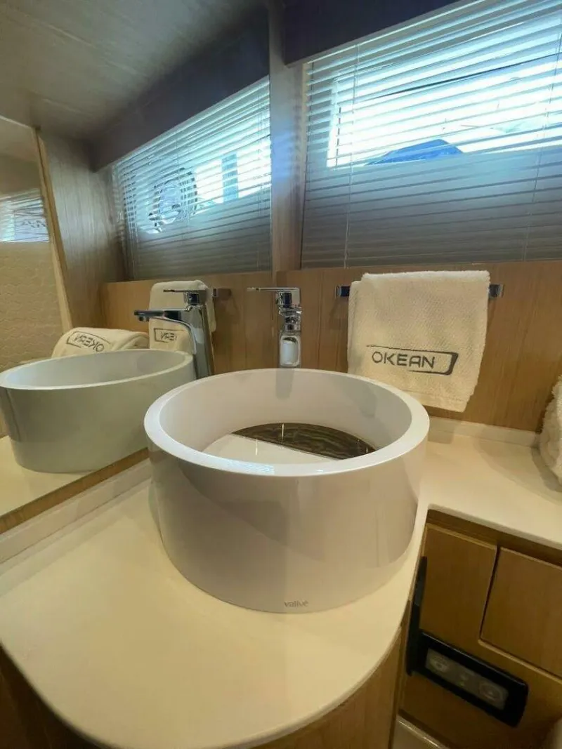 Slide: The Image of Modern bathroom sink on 2025 OKEAN 52 yacht with sleek design and branded towel. - 22