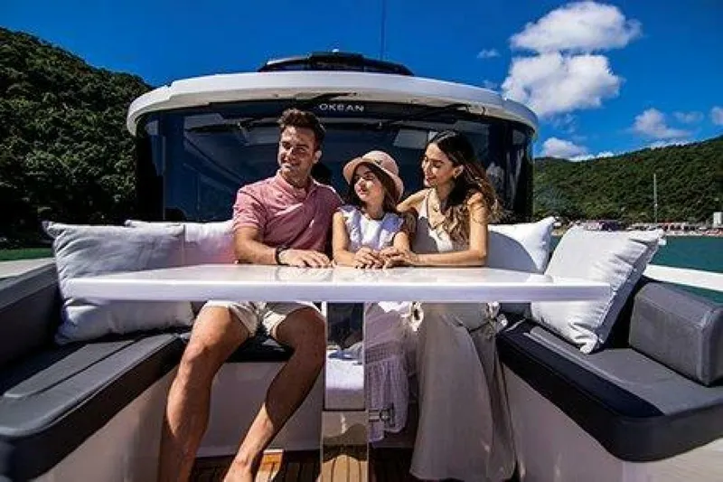 Slide: The Image of Family enjoying a sunny day on a 2025 OKEAN 52 yacht. - 38