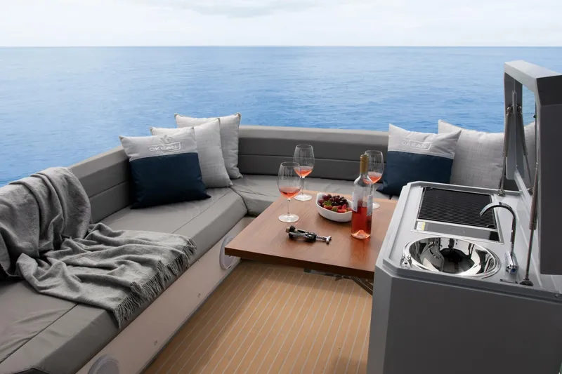 Slide: The Image of Luxurious OKEAN 52 yacht interior with cozy seating, wine, and ocean view, 2025 model. - 5