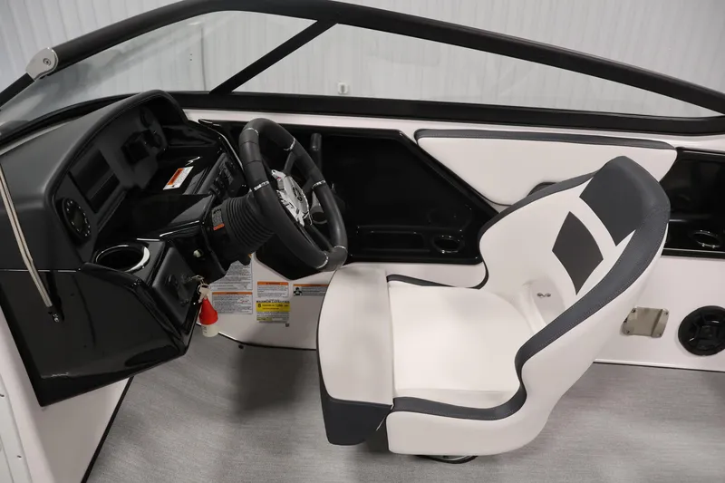 Slide: The Image of Interior of 2026 Yamaha Boats AR195, featuring sleek steering wheel and modern captain's chair. - 17