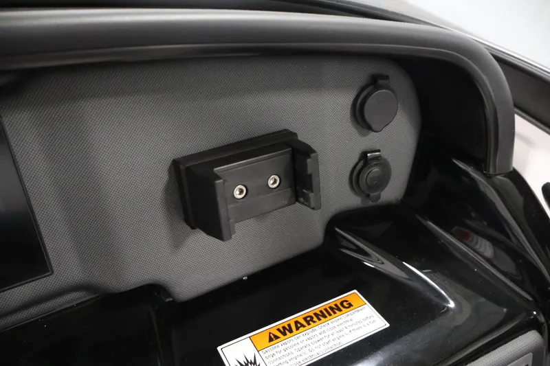 Slide: The Image of Dashboard of 2026 Yamaha Boats AR195 with warning label and accessory ports. - 22