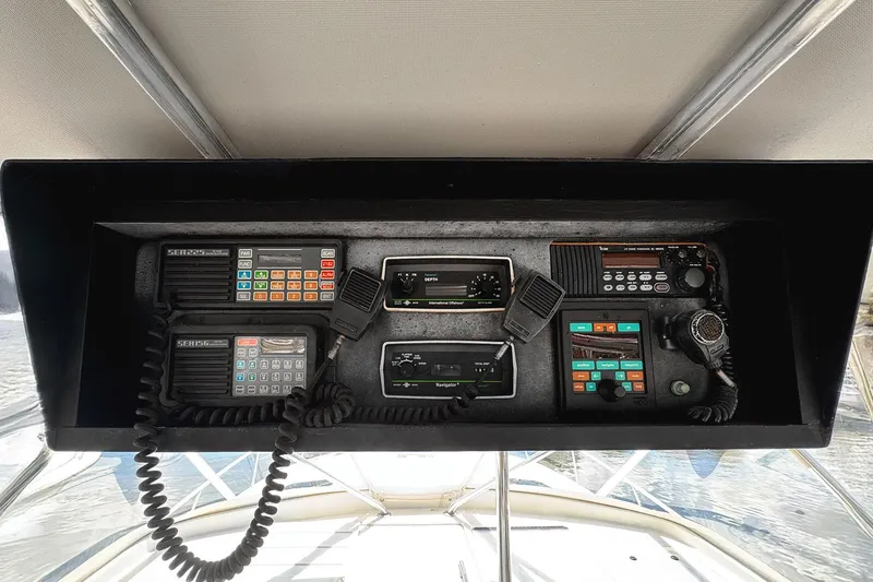 Slide: The Image of Control panel of a 1994 Luhrs 38 boat with communication and navigation equipment. - 18