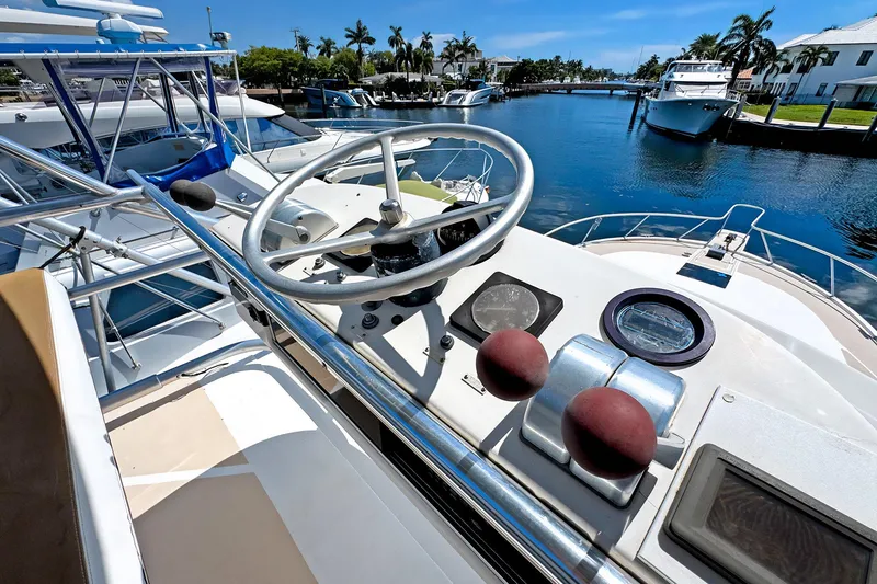 Slide: The Image of Helm of 1994 Luhrs 38 boat docked in a scenic marina. - 26