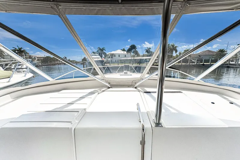 Slide: The Image of 1994 Luhrs 38 boat interior with marina view, featuring sleek design and clear blue skies. - 27