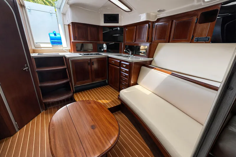 Slide: The Image of Luxurious 1994 Luhrs 38 yacht interior with wooden cabinetry and seating area. - 28