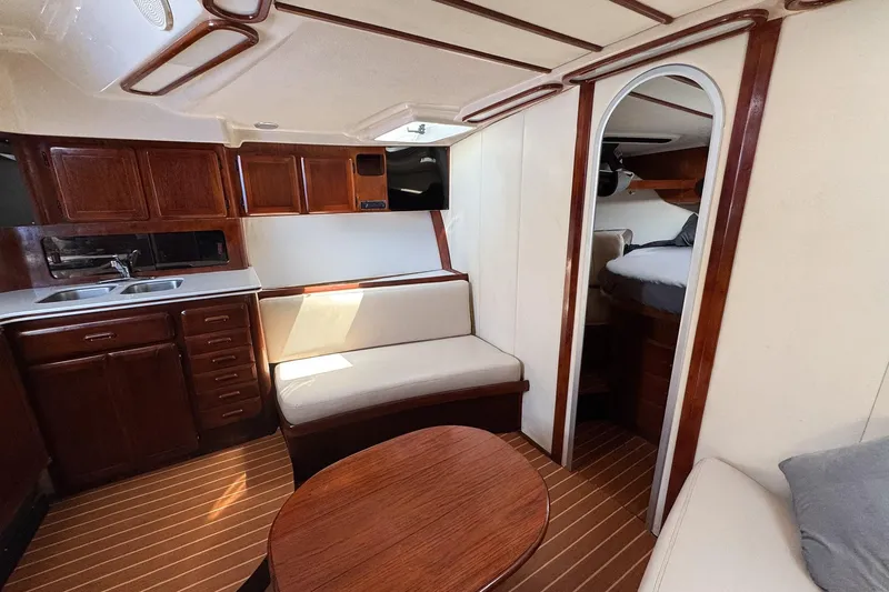 Slide: The Image of Interior of a 1994 Luhrs 38 boat with wood cabinetry and seating area. - 35