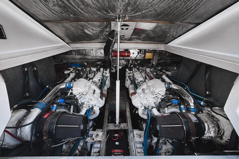 Slide: The Image of Engine room of a 1994 Luhrs 38 boat, showcasing dual engines and mechanical components. - 39