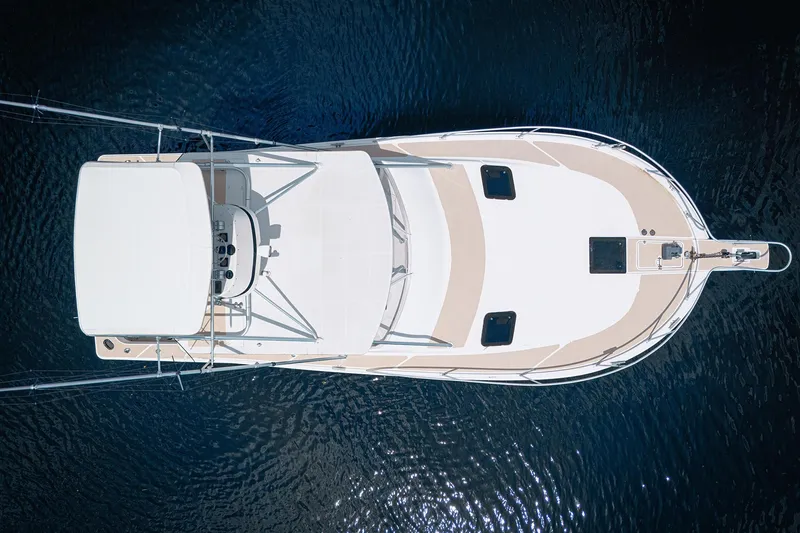 Slide: The Image of Overhead view of a 1994 Luhrs 38 boat on calm water. - 6
