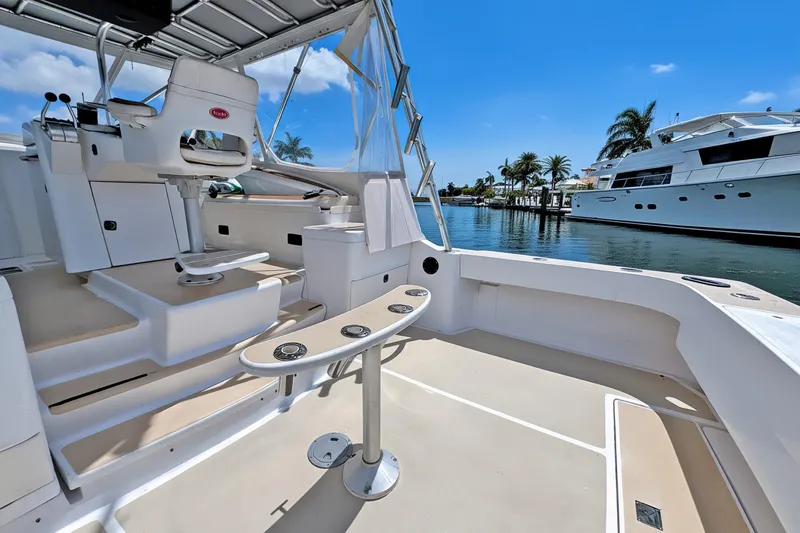 Slide: The Image of 1994 Luhrs 38 boat interior with helm, seating, and waterfront view. - 9