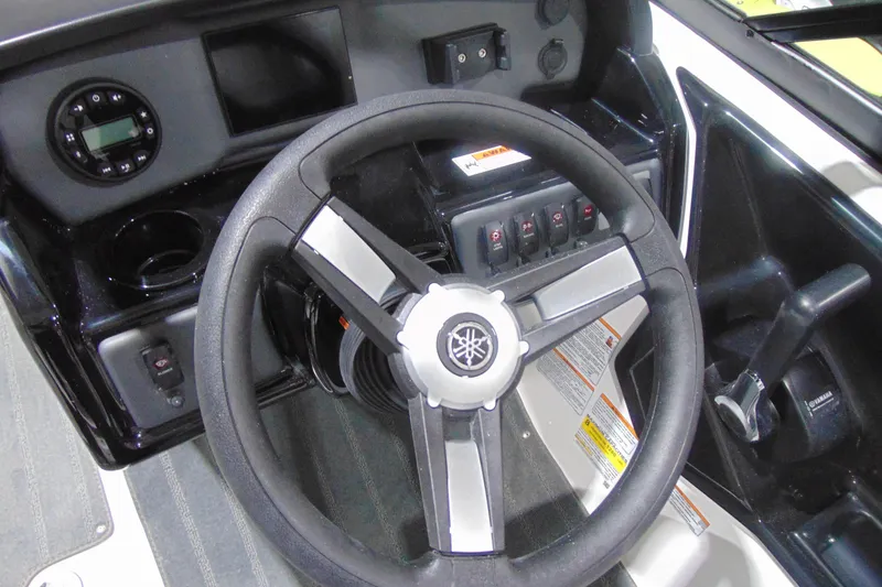Slide: The Image of 2026 Yamaha Boats AR190 steering wheel and dashboard controls. - 13