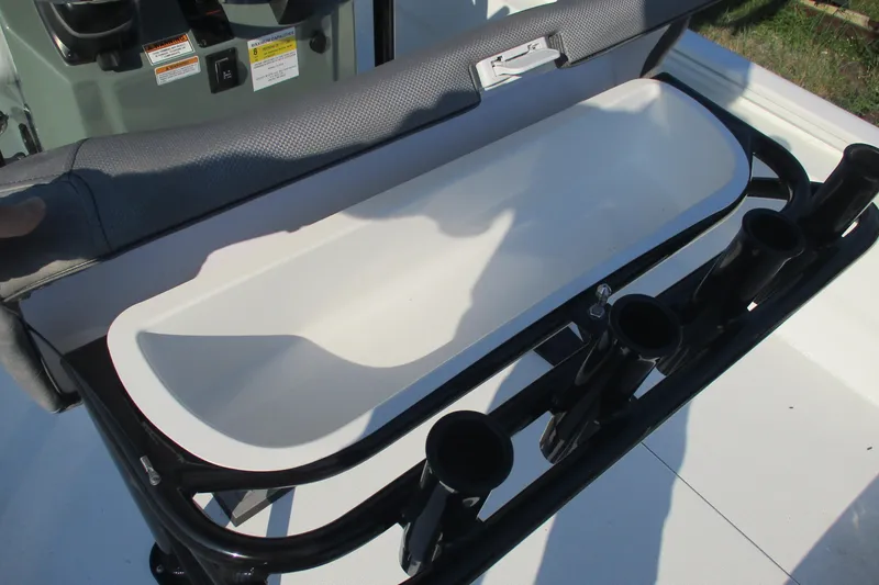 Slide: The Image of Open storage compartment on Avid 23 Fusion 2026 boat with rod holders. - 10