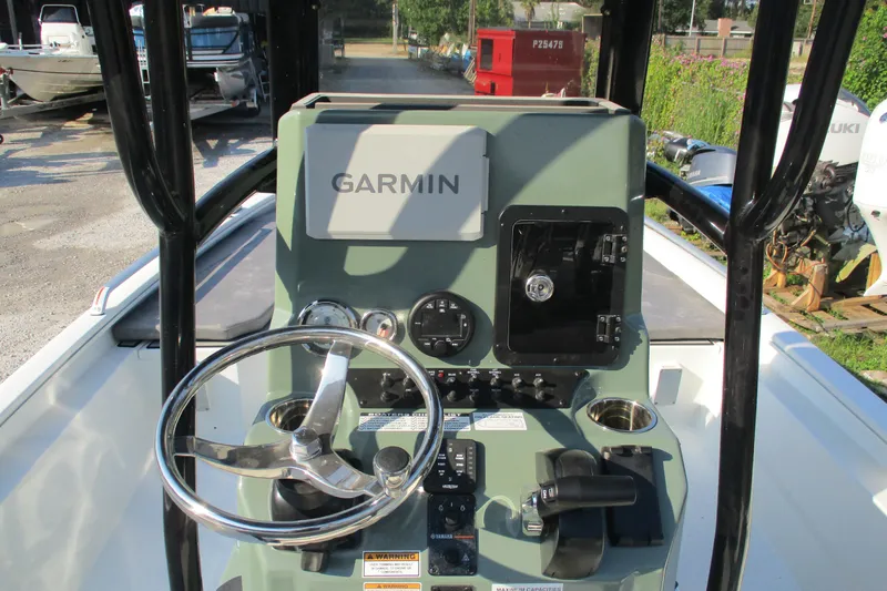 Slide: The Image of Avid 23 Fusion 2026 boat console with Garmin navigation system and steering wheel. - 11