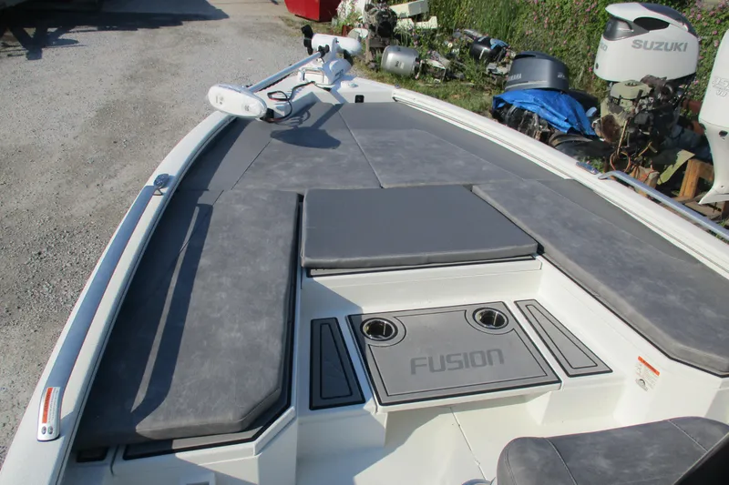 Slide: The Image of 2026 Avid 23 Fusion boat deck with cushioned seating and storage compartments. - 13