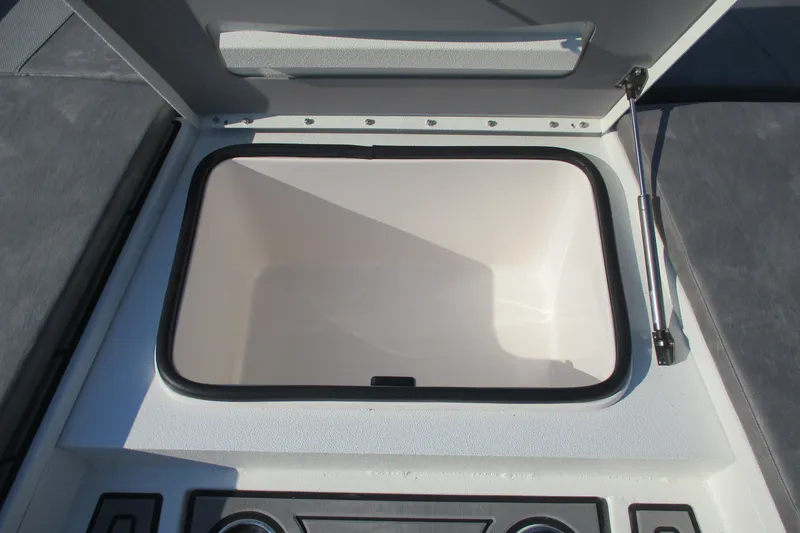 Slide: The Image of Open storage compartment on 2026 Avid 23 Fusion boat, featuring a hydraulic lift. - 14