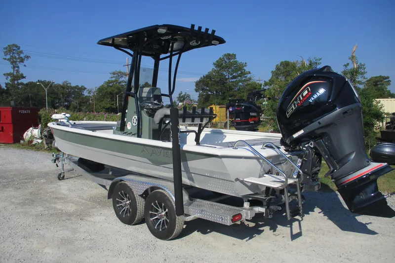 Slide: The Image of Avid 23 Fusion 2026 boat with Yamaha engine on a trailer in outdoor setting. - 5
