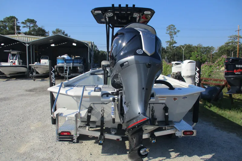 Slide: The Image of Avid 23 Fusion 2026 boat with Yamaha outboard motor in a marina setting. - 6