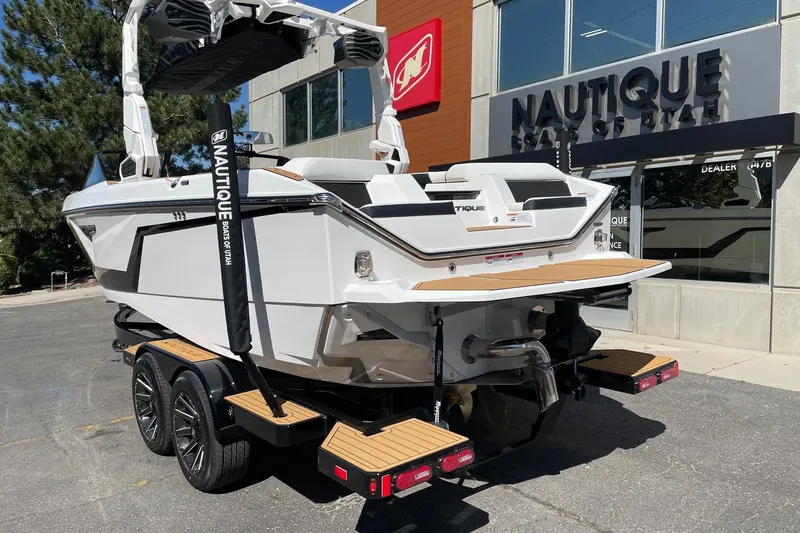 Slide: The Image of 2026 Nautique Super Air Nautique S23 boat displayed outside dealership. - 3