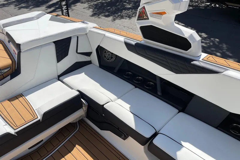 Slide: The Image of 2026 Nautique Super Air Nautique S23 interior with white seating and teak flooring. - 9