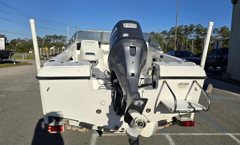 Slide: The Image of 2002 Angler 180DC boat with outboard motor, rear view in parking lot. - 4