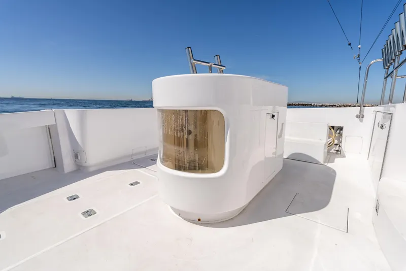 Slide: The Image of Hatteras 70 Convertible 2000 yacht deck with ocean view and clear blue sky. - 11