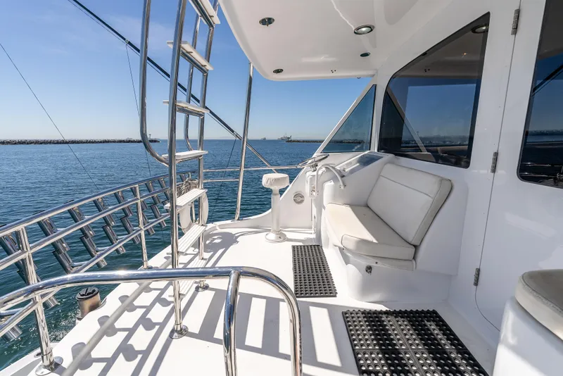 Slide: The Image of Hatteras 70 Convertible 2000 yacht deck with seating, ocean view, and stainless steel railings. - 13