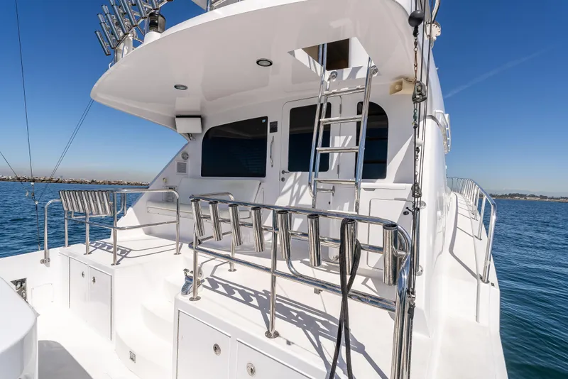 Slide: The Image of Hatteras 70 Convertible yacht, 2000 model, featuring spacious deck and sleek design on open water. - 14