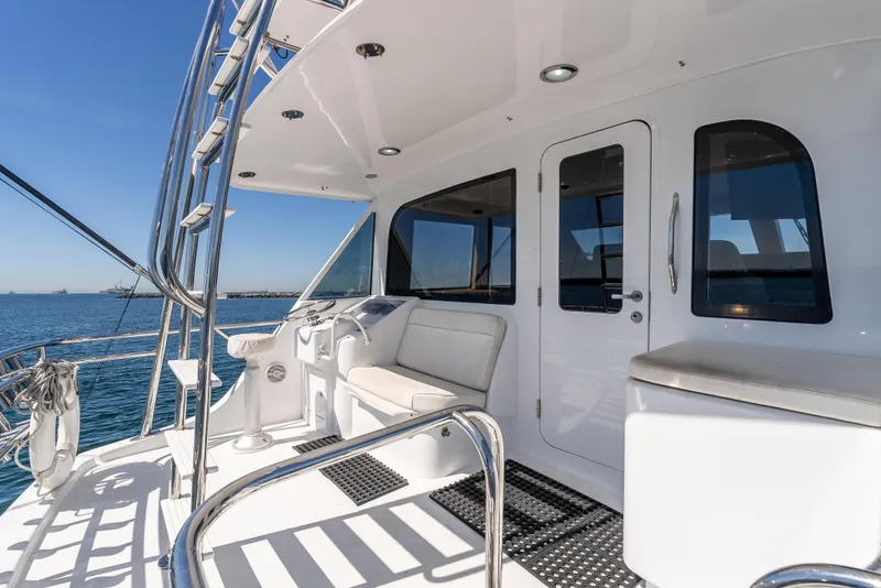 Slide: The Image of Hatteras 70 Convertible 2000 yacht deck with seating, ocean view, and sleek design. - 15