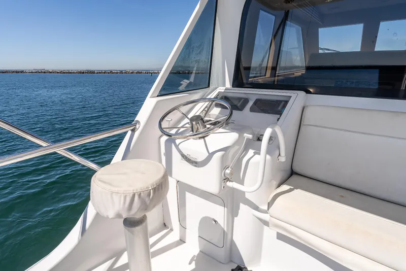 Slide: The Image of Helm of 2000 Hatteras 70 Convertible yacht with ocean view. - 16