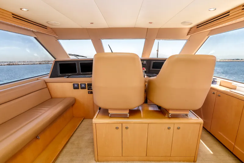 Slide: The Image of Interior of 2000 Hatteras 70 Convertible yacht with leather seating and panoramic windows. - 17