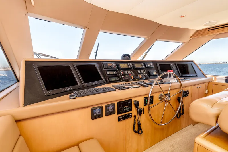 Slide: The Image of Cockpit of 2000 Hatteras 70 Convertible yacht with modern navigation equipment and steering wheel. - 21