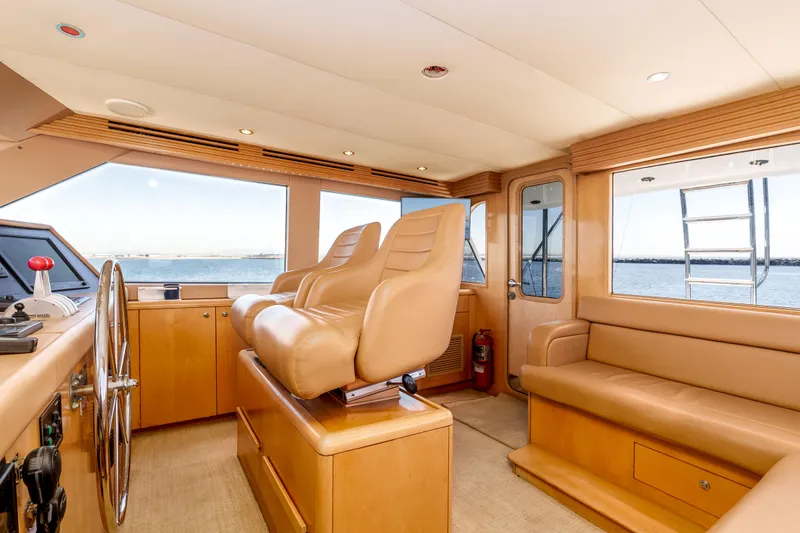 Slide: The Image of Luxurious interior of 2000 Hatteras 70 Convertible yacht with leather seating and panoramic windows. - 22