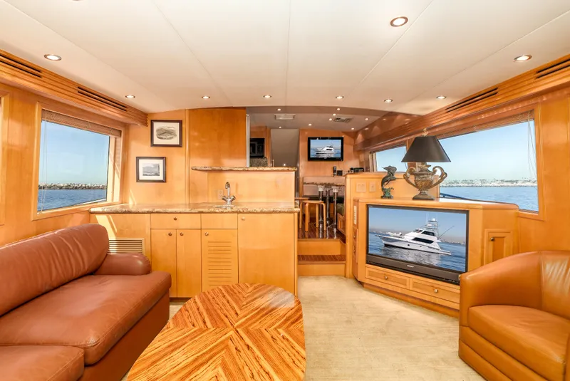 Slide: The Image of Luxurious interior of 2000 Hatteras 70 Convertible yacht with leather seating and wood finishes. - 23