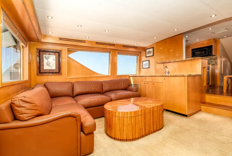 Slide: The Image of Luxurious interior of 2000 Hatteras 70 Convertible yacht with leather seating and wood finishes. - 24