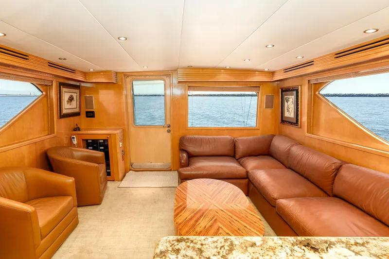 Slide: The Image of Luxurious interior of 2000 Hatteras 70 Convertible yacht with leather seating and ocean view. - 26