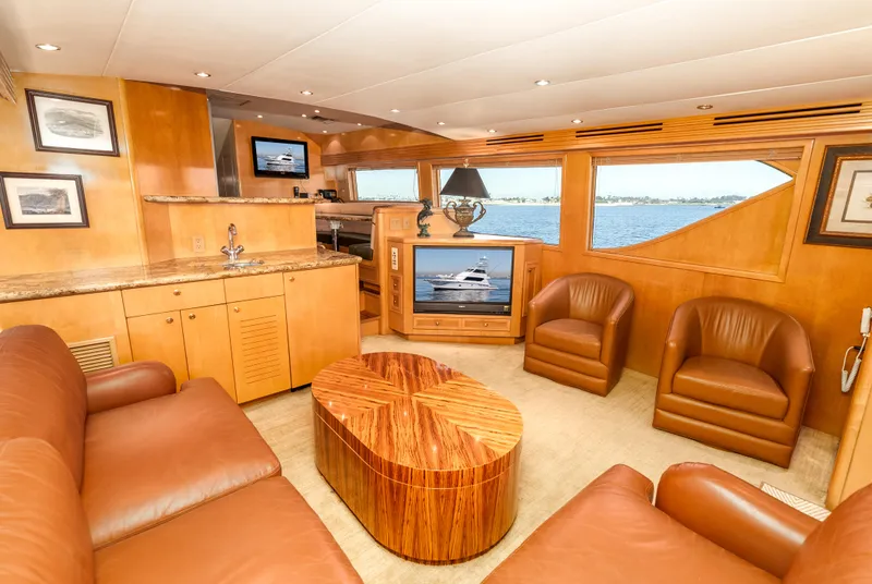 Slide: The Image of Luxurious interior of 2000 Hatteras 70 Convertible yacht with leather seating and wood finishes. - 28