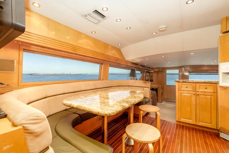 Slide: The Image of Luxurious interior of 2000 Hatteras 70 Convertible yacht with elegant dining area and ocean view. - 32