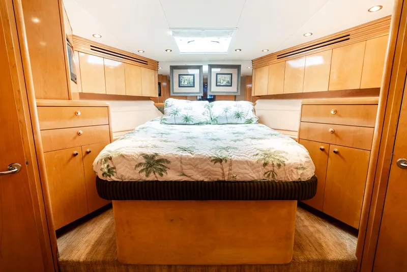 Slide: The Image of Luxurious bedroom interior of 2000 Hatteras 70 Convertible yacht with wood cabinetry and skylight. - 33
