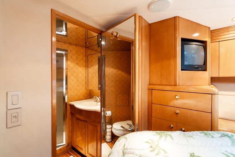 Slide: The Image of Interior of 2000 Hatteras 70 Convertible yacht with bathroom and wooden cabinetry. - 34