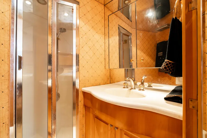 Slide: The Image of Luxurious bathroom in 2000 Hatteras 70 Convertible yacht with modern fixtures and elegant design. - 35