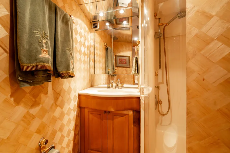 Slide: The Image of Luxurious bathroom in 2000 Hatteras 70 Convertible yacht with elegant wood finishes. - 36