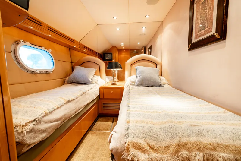 Slide: The Image of Luxurious cabin interior of 2000 Hatteras 70 Convertible yacht with twin beds and elegant decor. - 38
