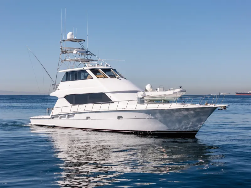 Slide: The Image of Hatteras 70 Convertible yacht, 2000 model, cruising on calm blue waters. - 4