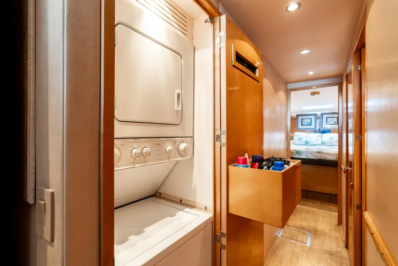 Slide: The Image of Laundry area and hallway inside a 2000 Hatteras 70 Convertible yacht. - 40