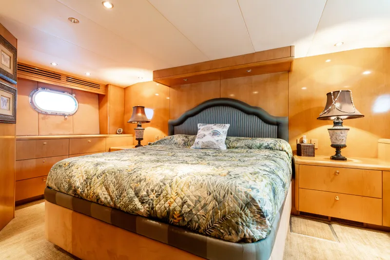 Slide: The Image of Luxurious bedroom interior of 2000 Hatteras 70 Convertible yacht with elegant decor and lighting. - 41