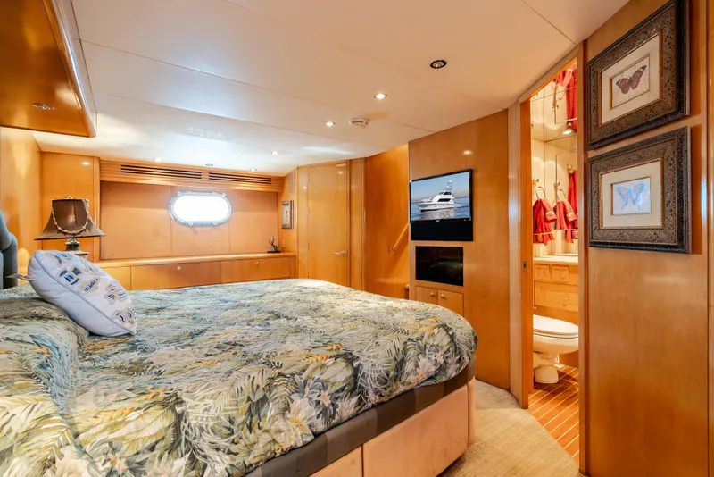 Slide: The Image of Luxurious bedroom interior of 2000 Hatteras 70 Convertible yacht with ensuite bathroom. - 43