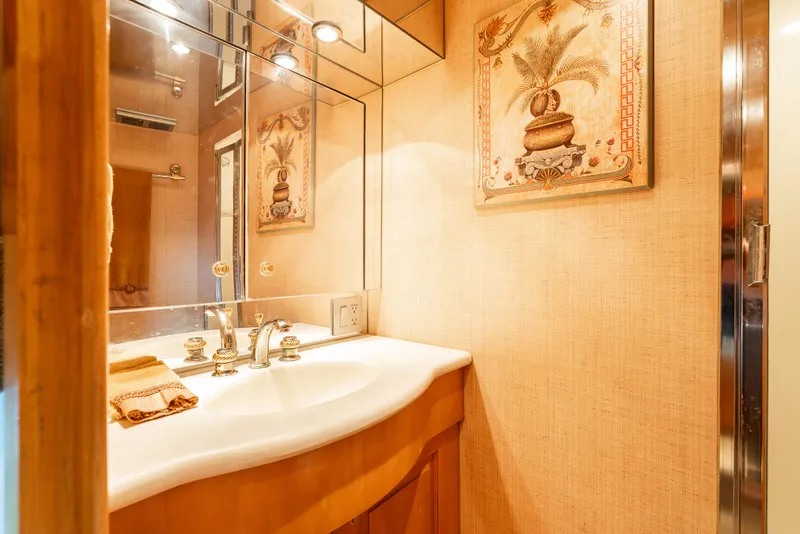 Slide: The Image of Luxurious bathroom interior on 2000 Hatteras 70 Convertible yacht, featuring elegant decor and fixtures. - 45